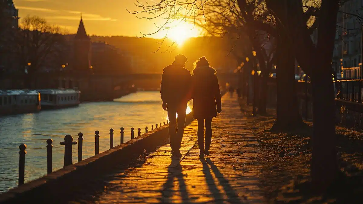 Romantic couple enjoying a sunset stroll beside the Saône River.