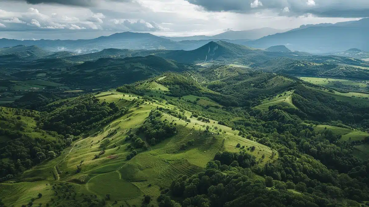 Aerial view of lush green hills surrounding La Clayette, perfect for cycling enthusiasts.